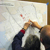 Man and woman standing at a housing opportunities map